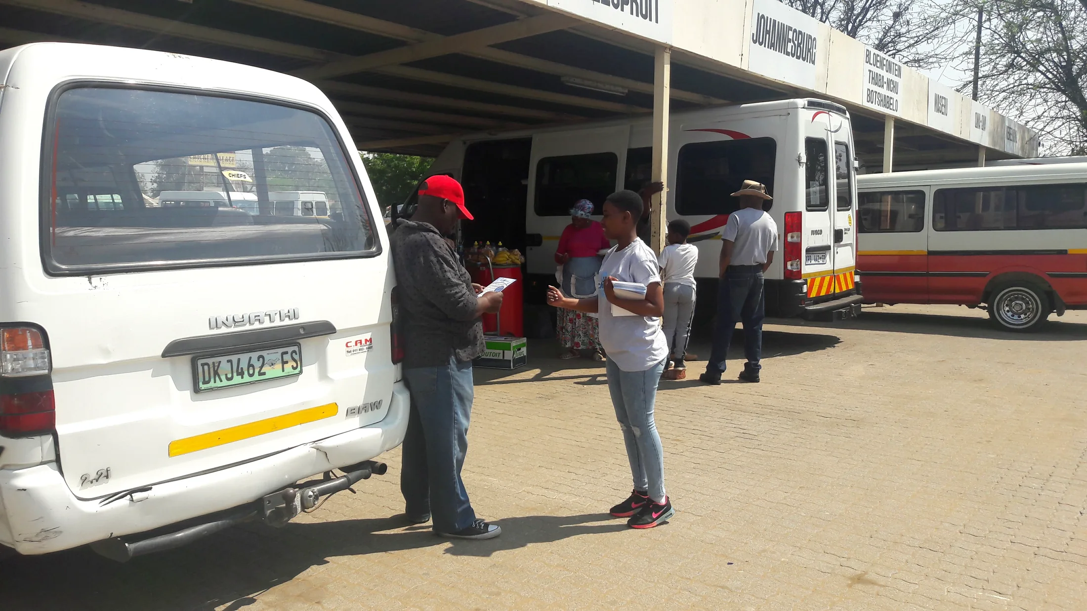 Leaflet distribution team working in an urban taxi-rank environment