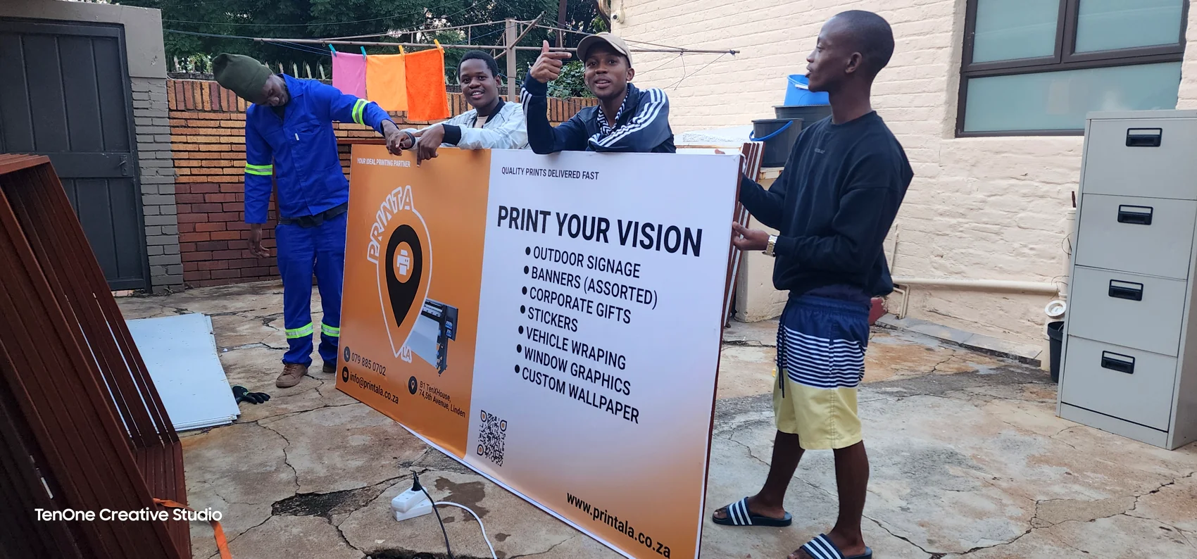 Team handling a large printed campaign board