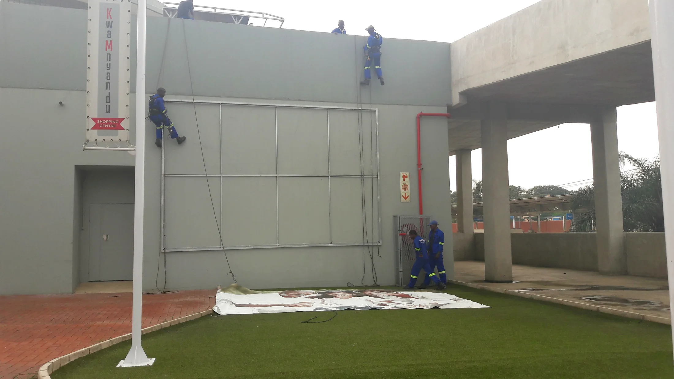 Outdoor media installation crew working on a billboard site